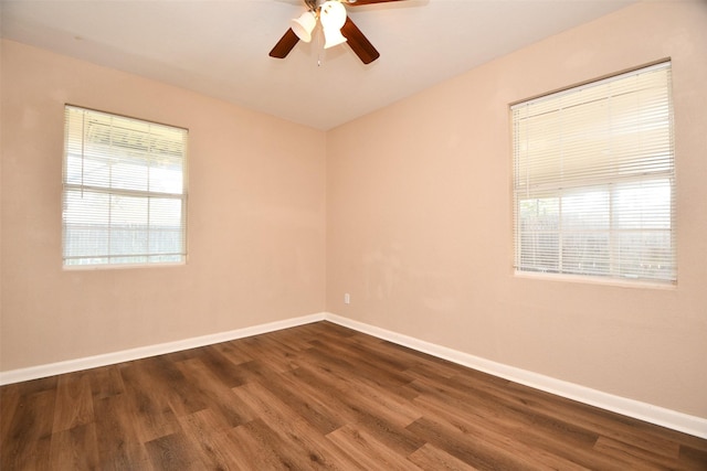 empty room with ceiling fan and dark hardwood / wood-style floors