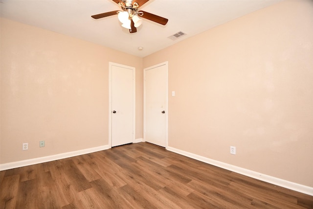 empty room with hardwood / wood-style flooring and ceiling fan