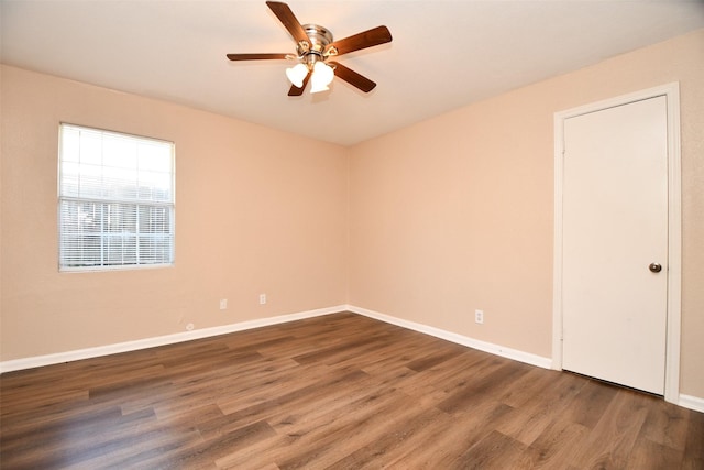 empty room featuring dark hardwood / wood-style floors and ceiling fan