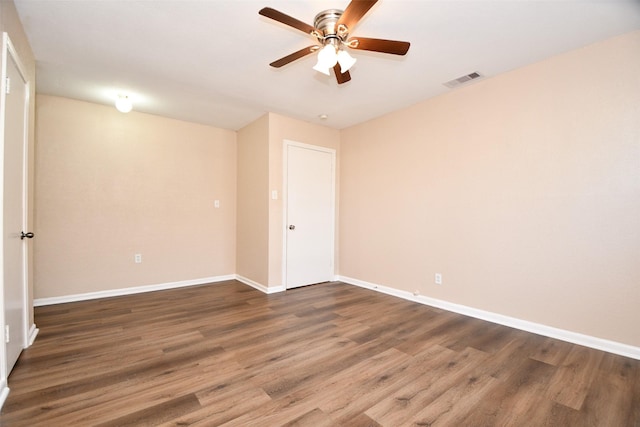 spare room with ceiling fan and dark hardwood / wood-style flooring