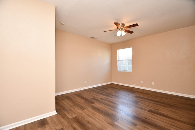 spare room featuring ceiling fan and dark hardwood / wood-style floors