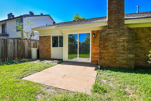 back of house with a patio and a yard