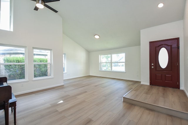 foyer with ceiling fan, plenty of natural light, light hardwood / wood-style floors, and high vaulted ceiling