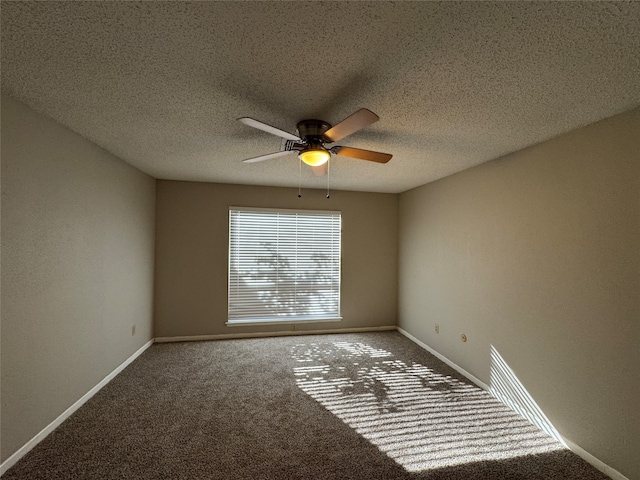 carpeted spare room featuring ceiling fan and a textured ceiling