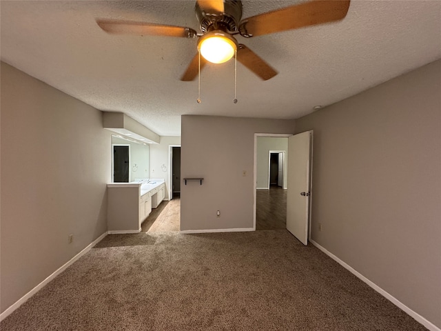 empty room with a textured ceiling, ceiling fan, and light carpet