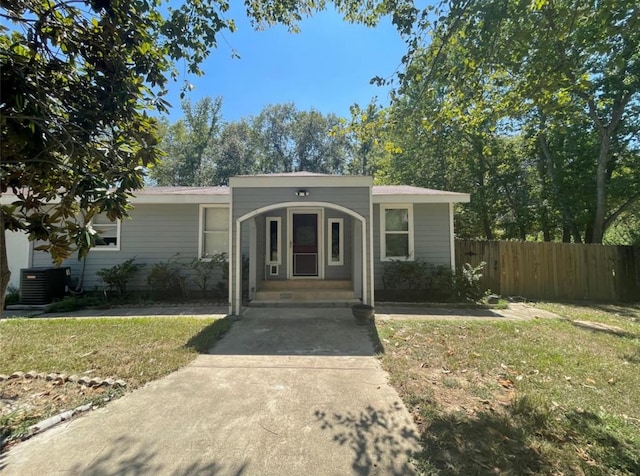 view of front of house featuring a front yard and cooling unit