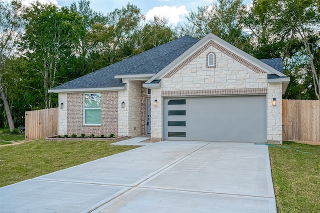 view of front of house featuring a front yard and a garage