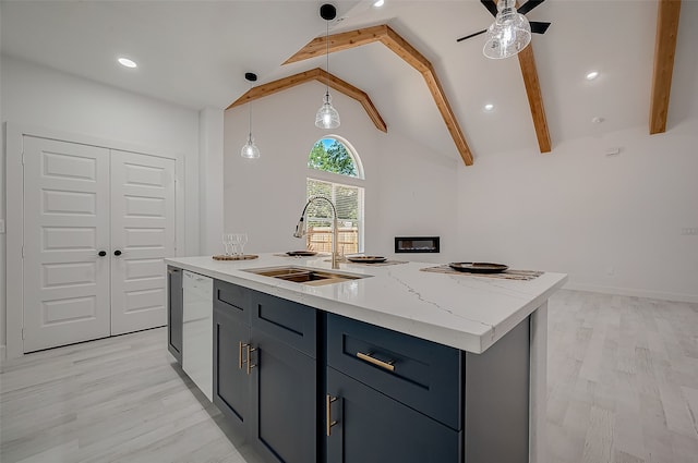 kitchen featuring vaulted ceiling with beams, a center island with sink, sink, and light hardwood / wood-style flooring