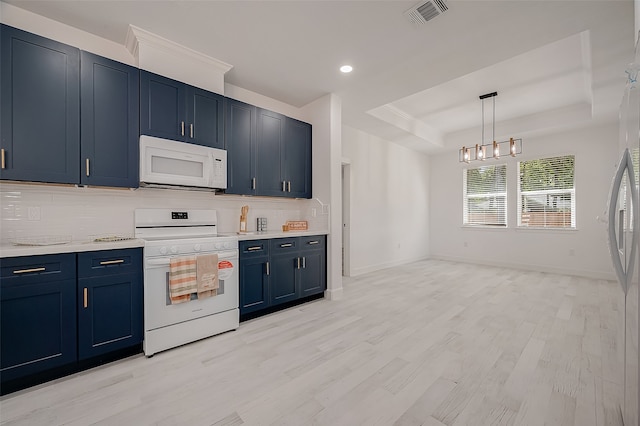 kitchen with light hardwood / wood-style floors, white appliances, a tray ceiling, blue cabinetry, and a notable chandelier