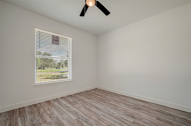 empty room featuring light wood-type flooring and ceiling fan