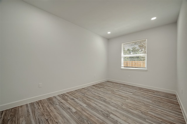 unfurnished room with light hardwood / wood-style floors