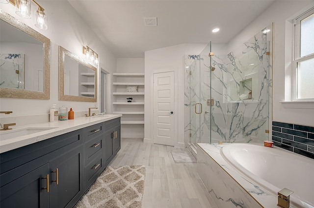 bathroom featuring hardwood / wood-style floors, shower with separate bathtub, vanity, and a healthy amount of sunlight