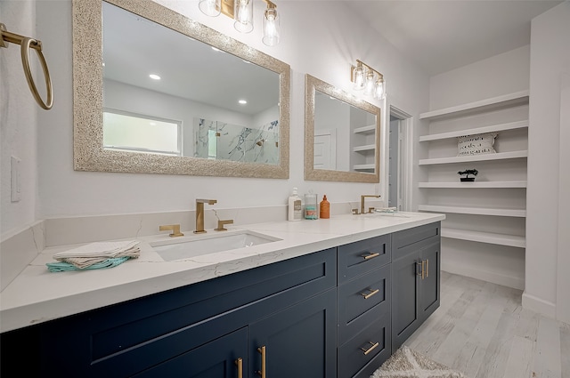 bathroom with hardwood / wood-style floors, a shower with shower door, and vanity