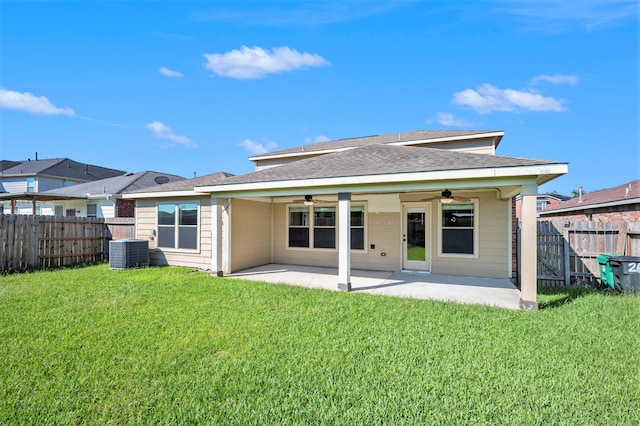 rear view of property with a patio, a yard, ceiling fan, and central AC unit