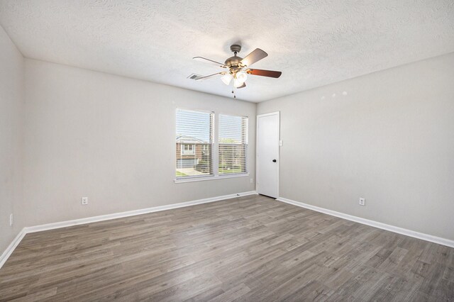 unfurnished room with a textured ceiling, ceiling fan, and hardwood / wood-style flooring