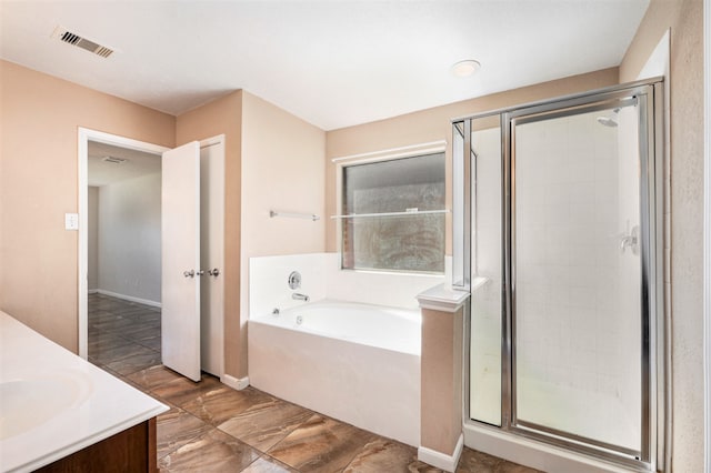 bathroom featuring shower with separate bathtub and vanity