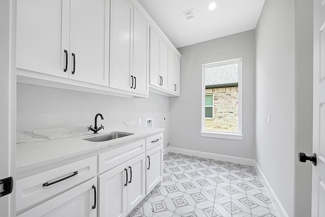 laundry room with sink, electric dryer hookup, washer hookup, and cabinets