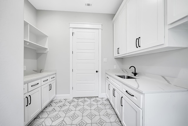 clothes washing area featuring sink