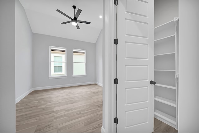 unfurnished room featuring light hardwood / wood-style flooring, lofted ceiling, and ceiling fan