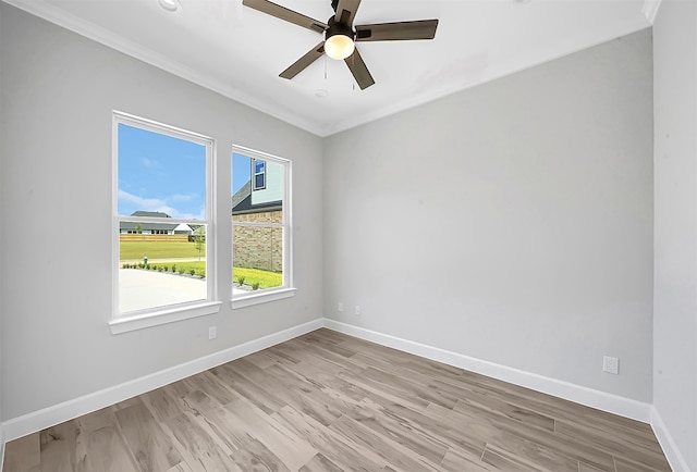 empty room featuring light hardwood / wood-style flooring, ceiling fan, and crown molding