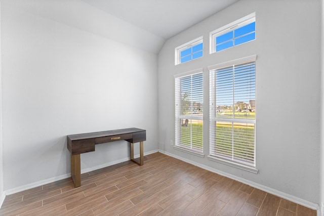 unfurnished room featuring vaulted ceiling