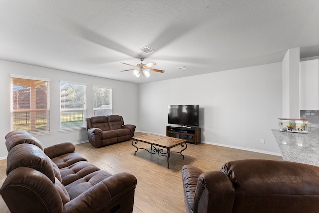 living room featuring light wood-type flooring and ceiling fan