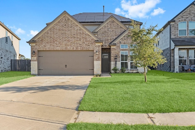 view of front of home with solar panels, a garage, and a front lawn