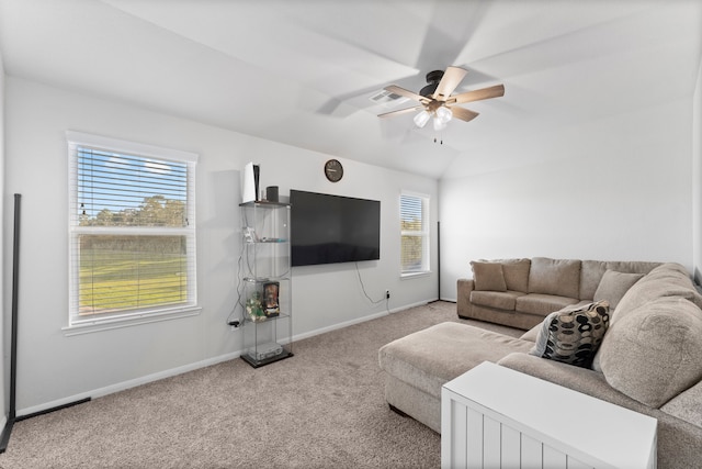 living room with ceiling fan, carpet floors, and lofted ceiling