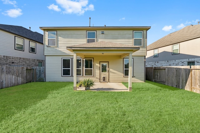 back of house with a patio area and a yard