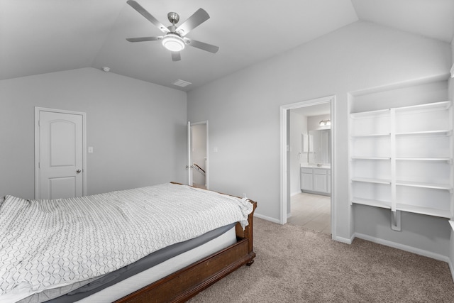 carpeted bedroom featuring ensuite bath, ceiling fan, and vaulted ceiling