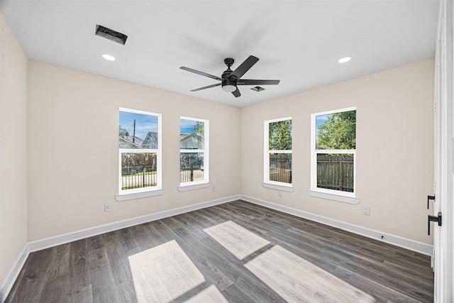 spare room with ceiling fan and dark hardwood / wood-style flooring