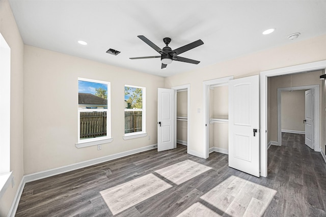 unfurnished bedroom featuring dark hardwood / wood-style flooring and ceiling fan