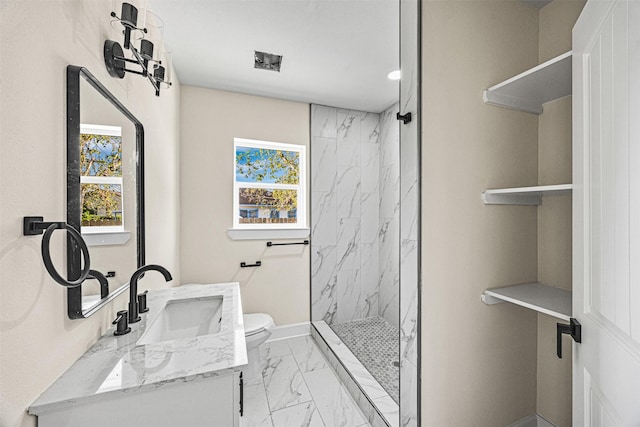 bathroom featuring tiled shower, vanity, and toilet