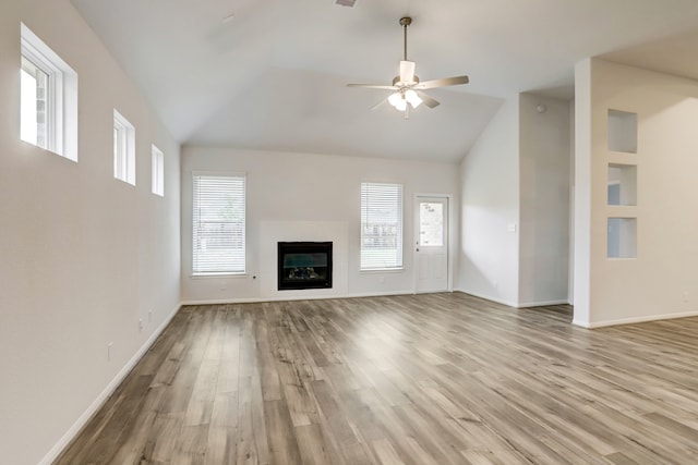 unfurnished living room featuring light hardwood / wood-style floors, vaulted ceiling, and ceiling fan