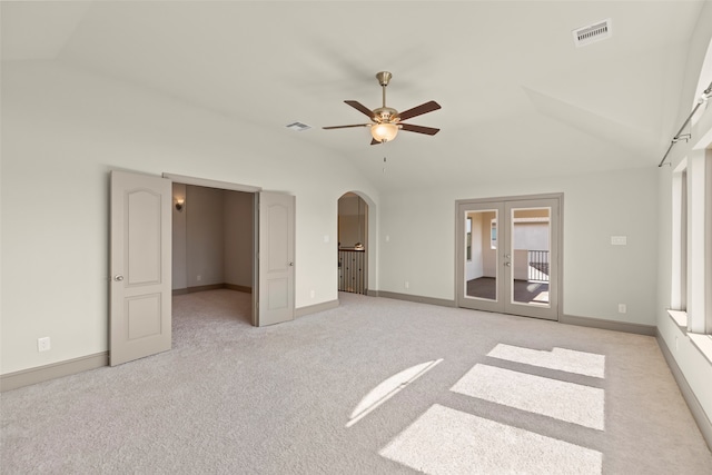 unfurnished bedroom featuring lofted ceiling, ceiling fan, and light colored carpet