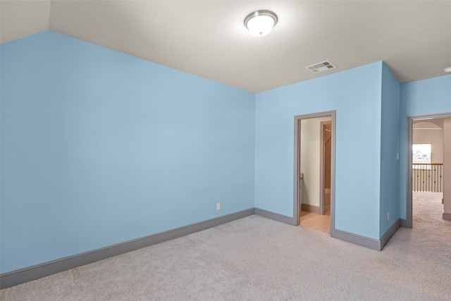 unfurnished bedroom featuring lofted ceiling and light colored carpet