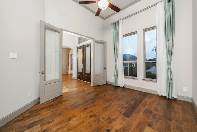 unfurnished room featuring french doors, ornamental molding, dark hardwood / wood-style flooring, and ceiling fan