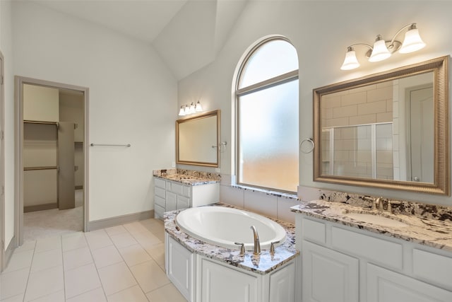 bathroom featuring independent shower and bath, lofted ceiling, vanity, and tile patterned floors