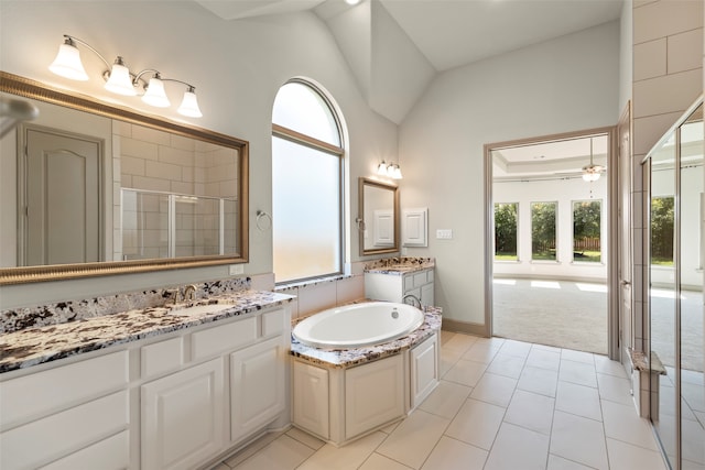 bathroom featuring ceiling fan, vanity, lofted ceiling, independent shower and bath, and tile patterned flooring