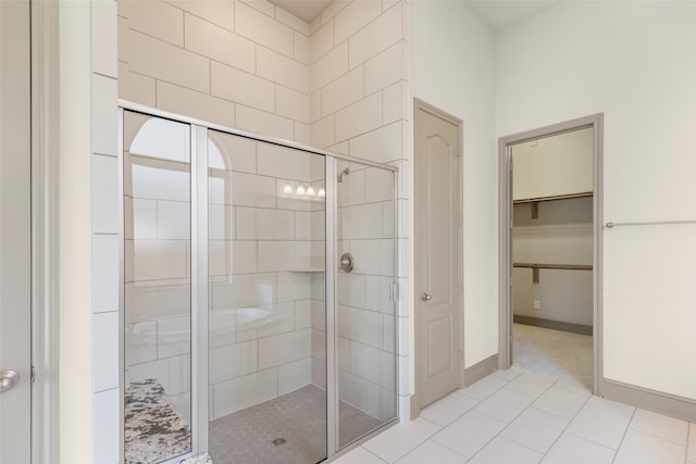 bathroom featuring a shower with shower door and tile patterned flooring