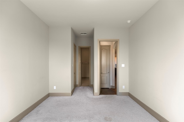 unfurnished bedroom featuring light colored carpet