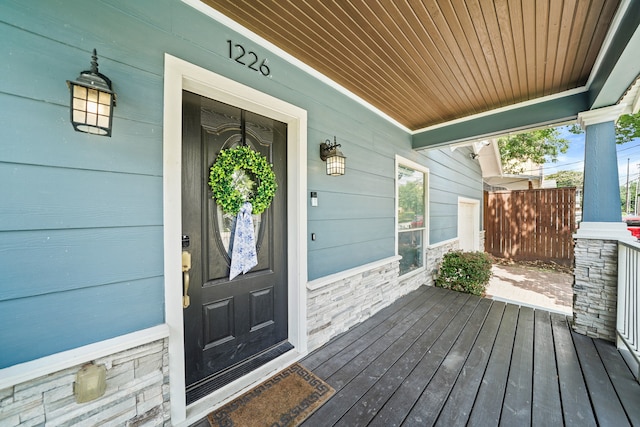 view of exterior entry with a porch