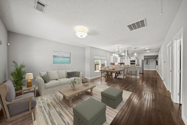 living room with wood-type flooring and a textured ceiling