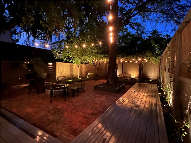 deck at twilight with an outdoor hangout area and a patio