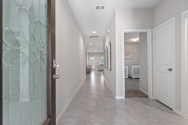 hallway featuring light tile patterned floors