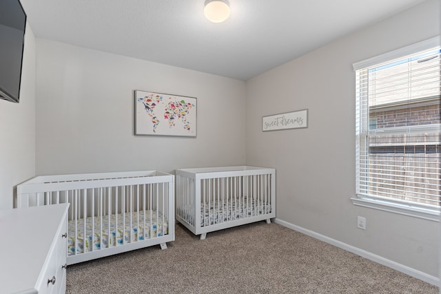 unfurnished bedroom with carpet floors and a nursery area