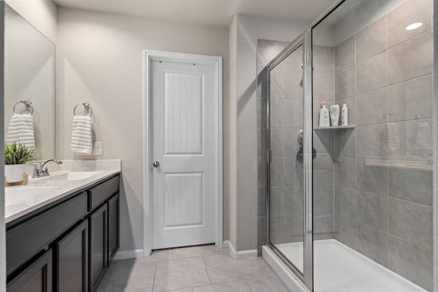 bathroom with tile patterned floors, vanity, and a shower with shower door