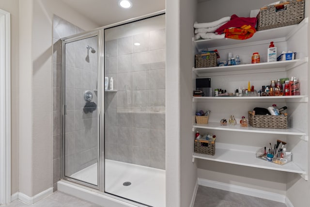 bathroom with tile patterned floors and an enclosed shower