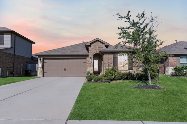 view of front of home with a lawn and a garage