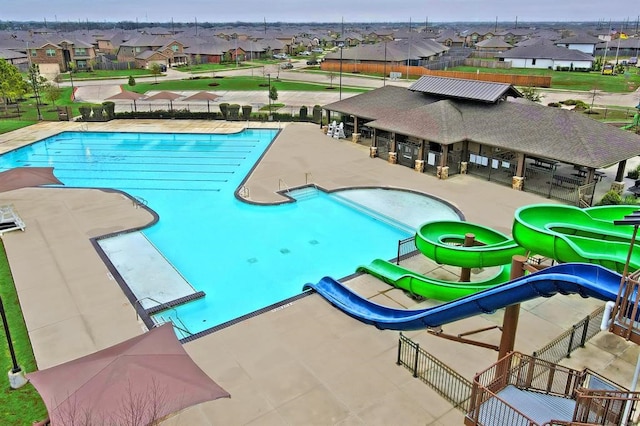 view of swimming pool featuring a patio and a water slide